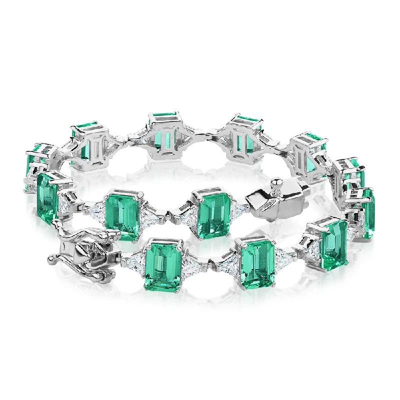 Flash Sale On Exquisite Jewelry – Don't Miss Out Emerald Cut and Trilliant tennis bracelet with ocean green simulants and 3.12 carats* of diamond simulants in sterling silver