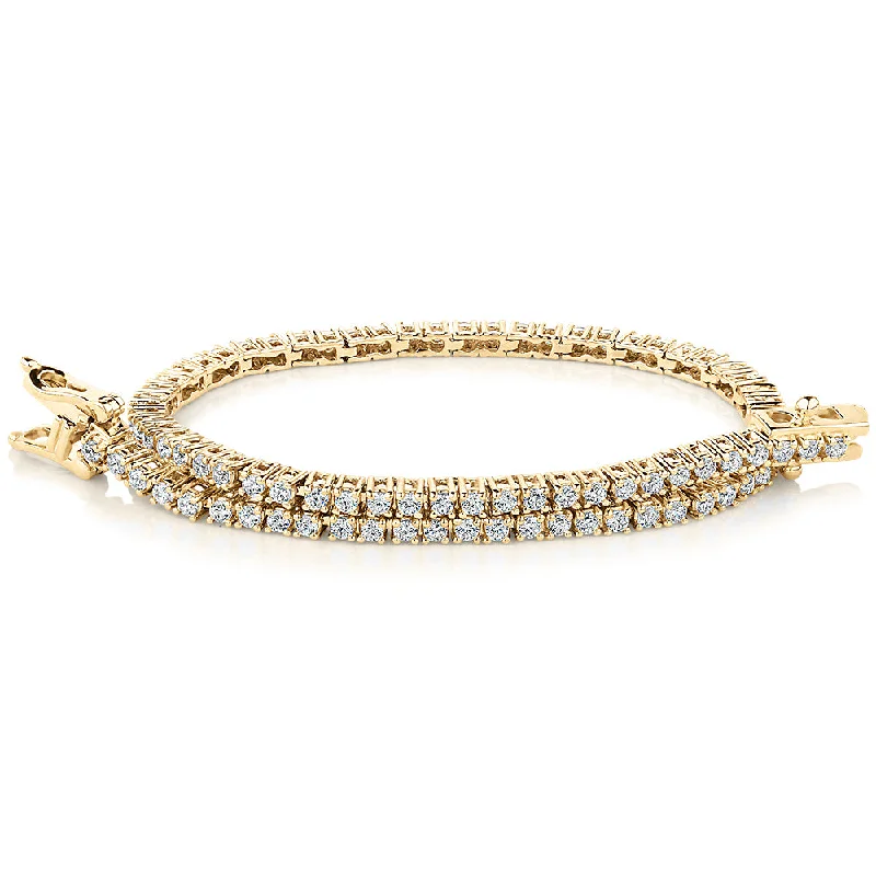 Delicate Crystal Jewelry For Sophisticated Charm Round Brilliant tennis bracelet with 1.29 carats* of diamond simulants in 10 carat yellow gold