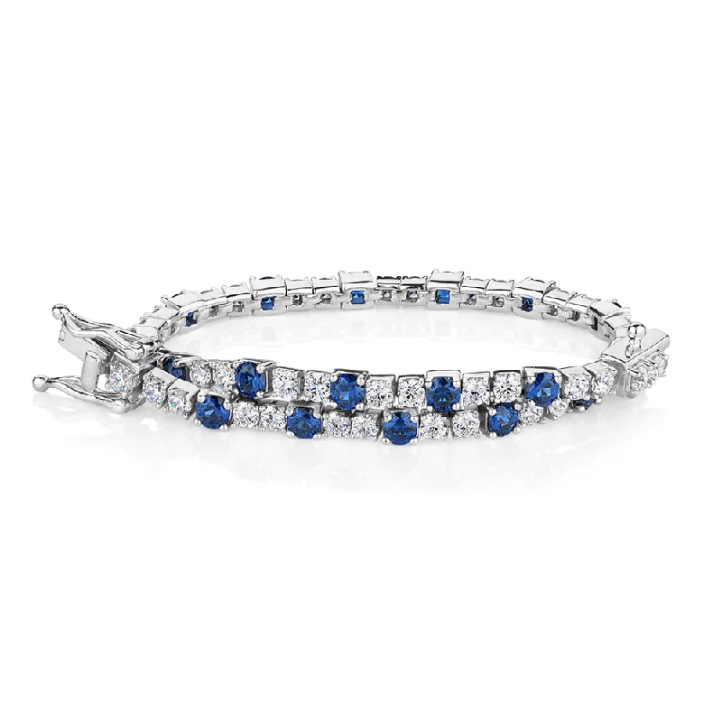 Must-Have Jewelry Pieces At Reduced Prices Round Brilliant tennis bracelet with sapphire simulants and 3.28 carats* of diamond simulants in sterling silver