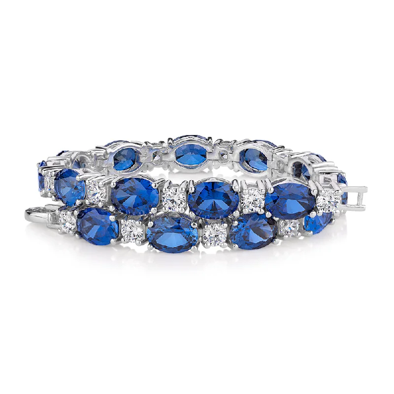 Shop Dazzling Jewelry At The Best Prices Oval and Round Brilliant tennis bracelet with sapphire simulants and 3.36 carats* of diamond simulants in sterling silver Shop Dazzling Jewelry At The Best Prices Oval and Round Brilliant tennis bracelet with sapphire simulants and 3.36 carats* of diamond simulants in sterling silver
